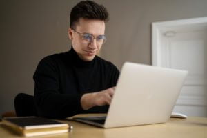 programmer uses laptop freelancer office work man